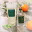 4711 Acqua Colonia Blood Orange & Basil Flakon und Duschgel neben Basilikumblätter und Blutorangen