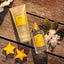 4711 Acqua Colonia Starfruit & White Flowers Flakon und Duschgel neben Sternfrüchten und weißen Blüten